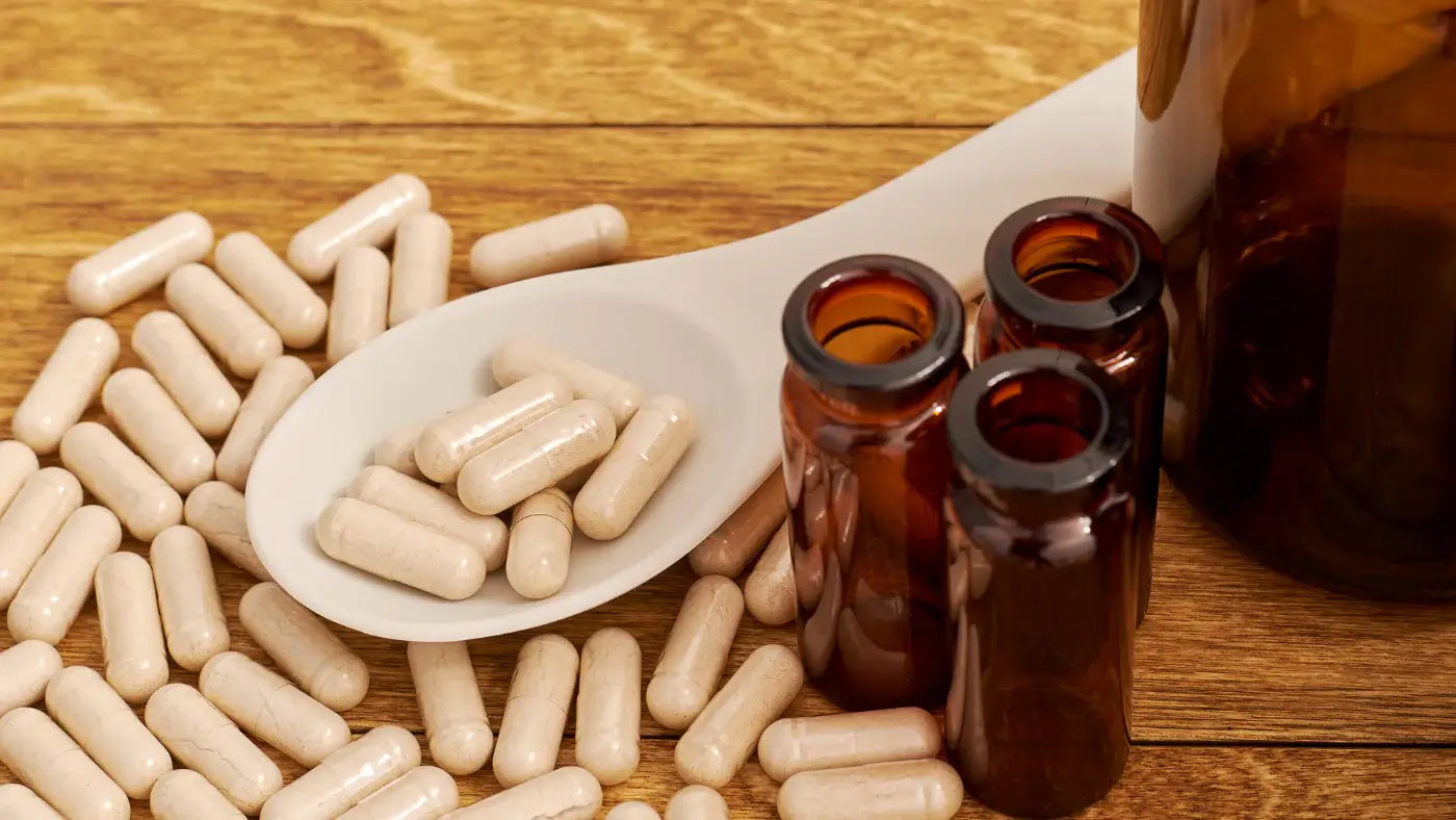 A lot of CBD Capsules in the table over a spoon