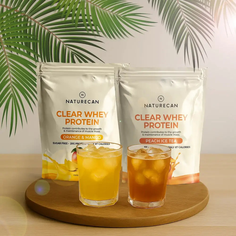 Packets of Fruity Whey Protein Isolate, Orange & Mango and Peach Ice Tea flavors, with two glasses of iced drinks.