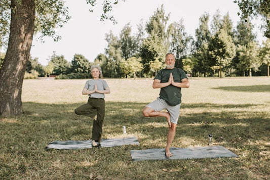 two people doing balance exercises in a park