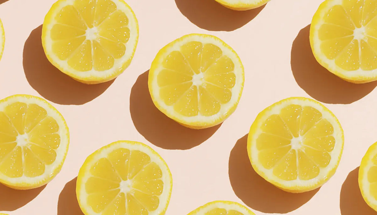 half oranges over pìnk background