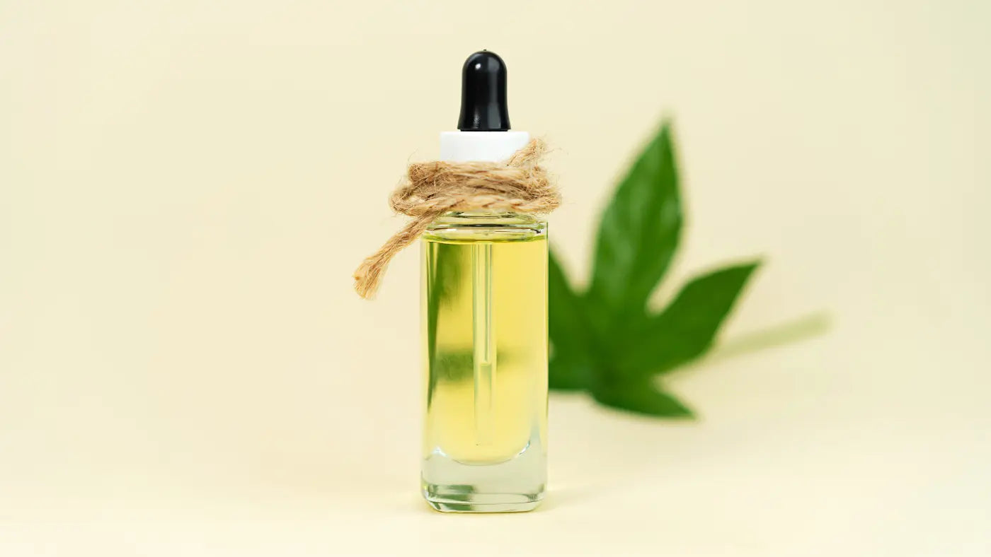 THC oil on flask over yellow background