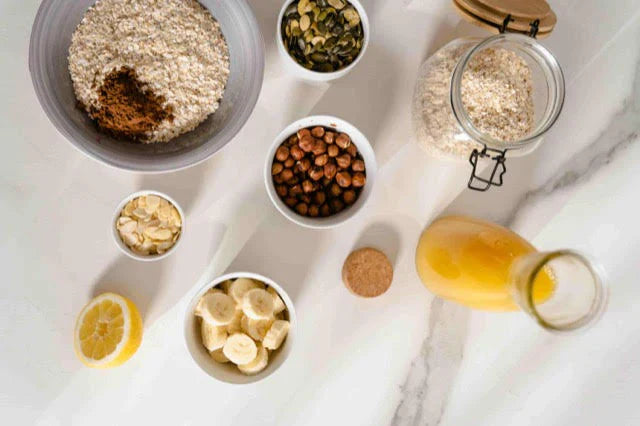 table with oats, hazelnuts, lemon, banana, orange juice, etc.