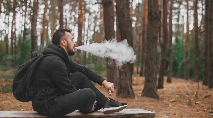 Man sitting and vaping 