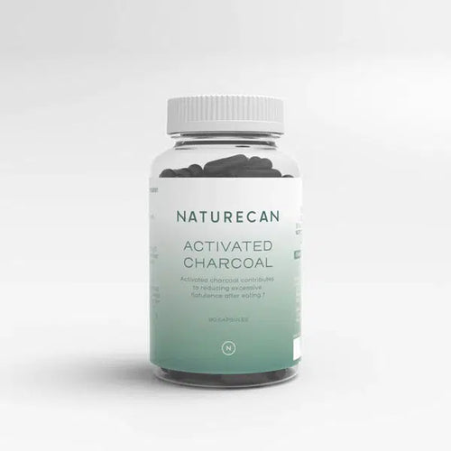 A bottle of Naturecan Activated Charcoal with a white and green label is shown.