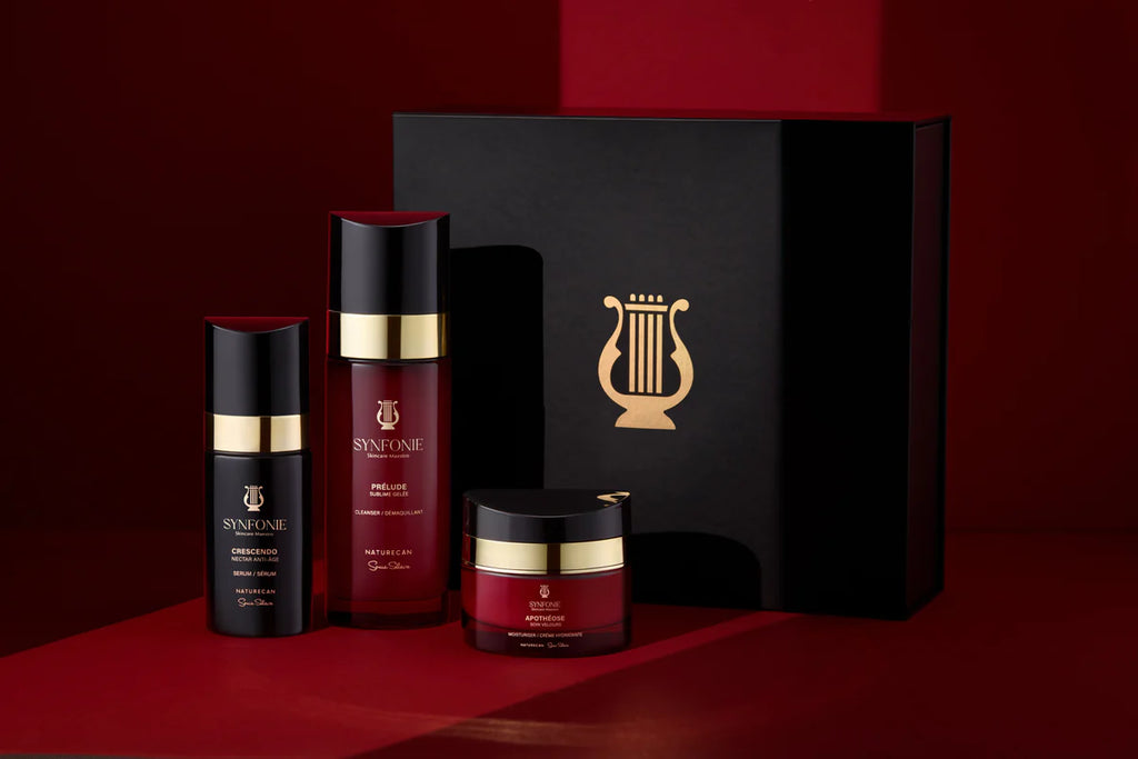Cosmetic set with bottles and a jar on a red background, featuring a prominent logo.