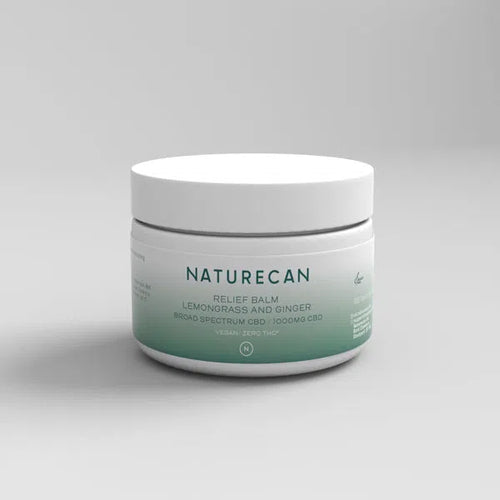 A white jar labeled "Naturecan Relief Balm Lemongrass and Ginger" with a green gradient base.