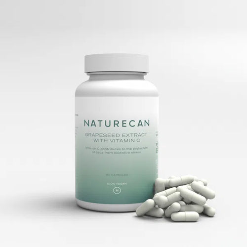 Bottle of Naturecan Grapeseed Extract with Vitamin C, surrounded by scattered capsules.