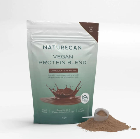 A bag of Naturecan Vegan Protein Blend in chocolate flavour with protein powder and a scoop beside it.