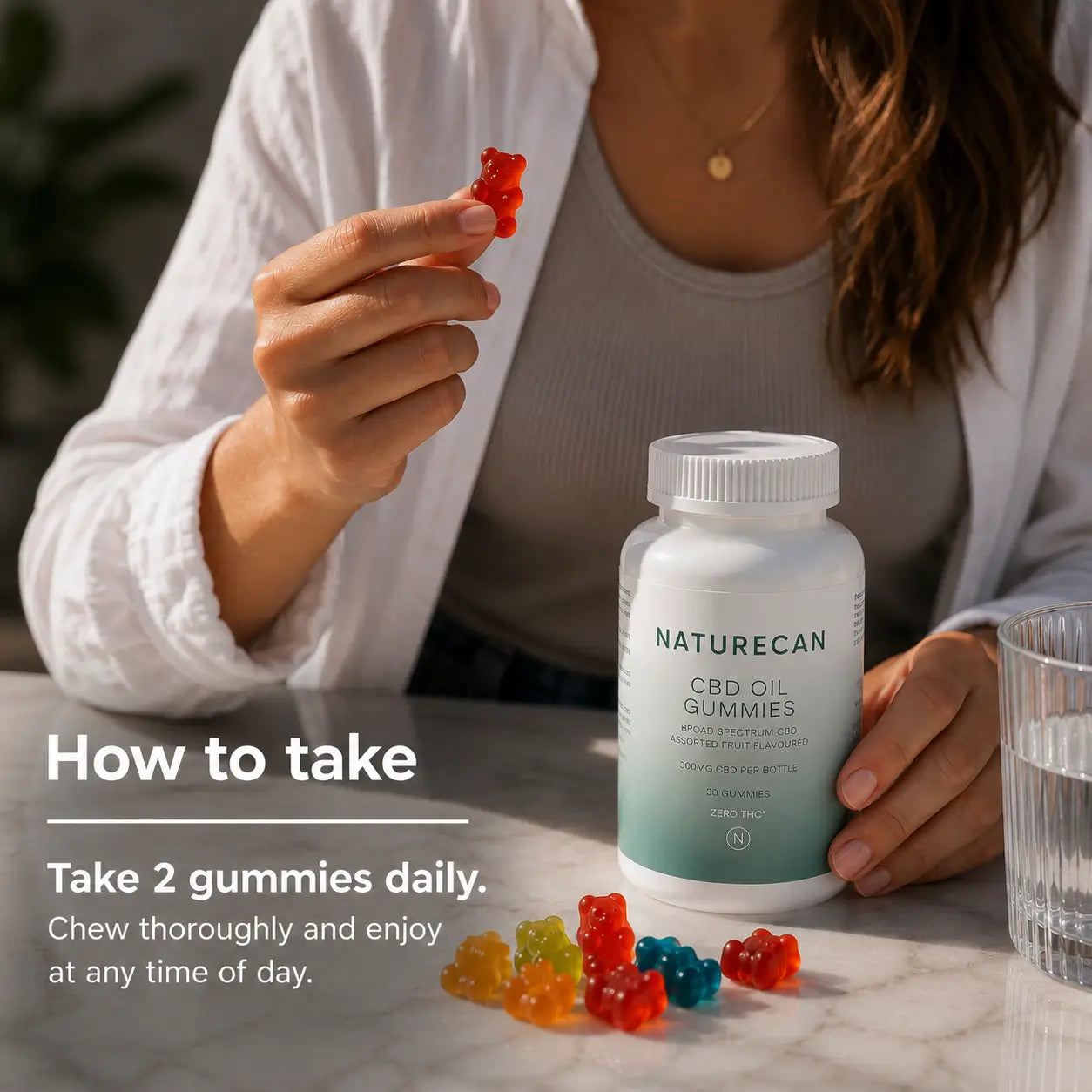 A woman holds a red gummy bear next to a bottle of Naturecan CBD Oil Gummies on a marble table, with text overlay explaining how to take the gummies.