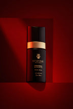 Black and gold skincare bottle with 'SYNfonie' branding on a red background